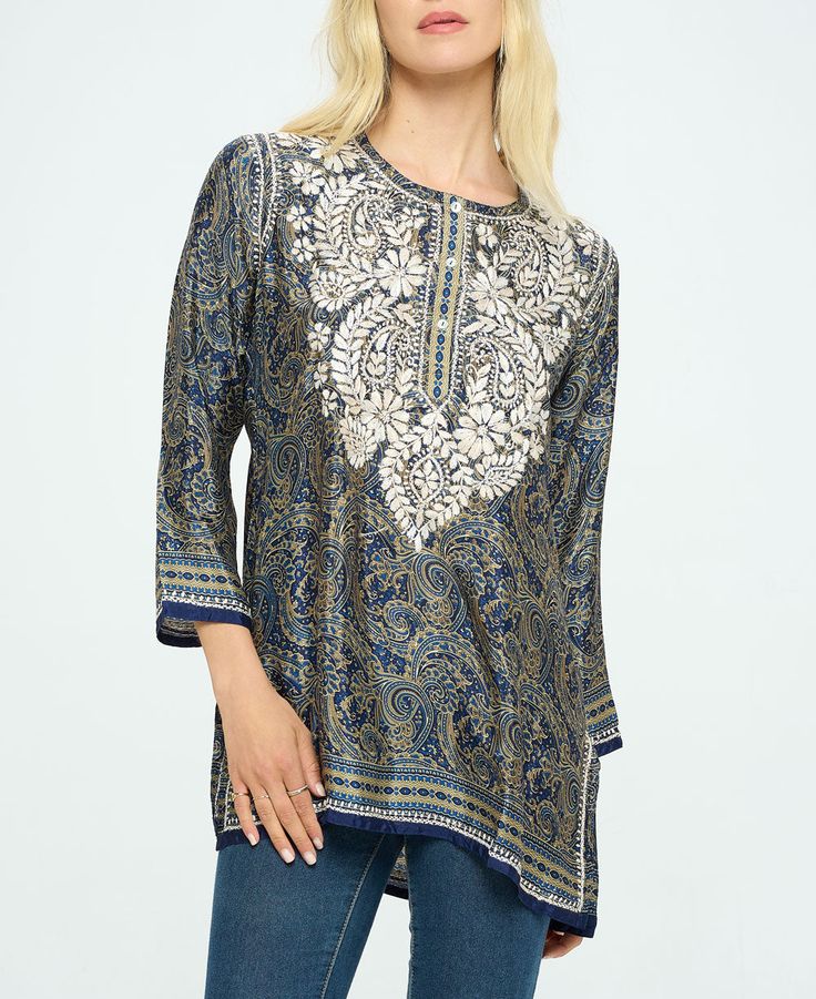 Featuring opulent patterns in rich colors, the Midnight Desert tunic showcases traditional Indian handicrafts with embroidered florals at the neck and hem. Topped with a buttoned henley neckline and side slits, it's made from a lux poly-silk blend. Embroidered Indian-style tunic Made from a polyester and silk blend 72% – Polyestere, 28% – Silk Henley neckline, vented hem Shades of midnight blue with sand-colored embroidery Made in India Garment Flat Measurement (Inches): Please note that the mea