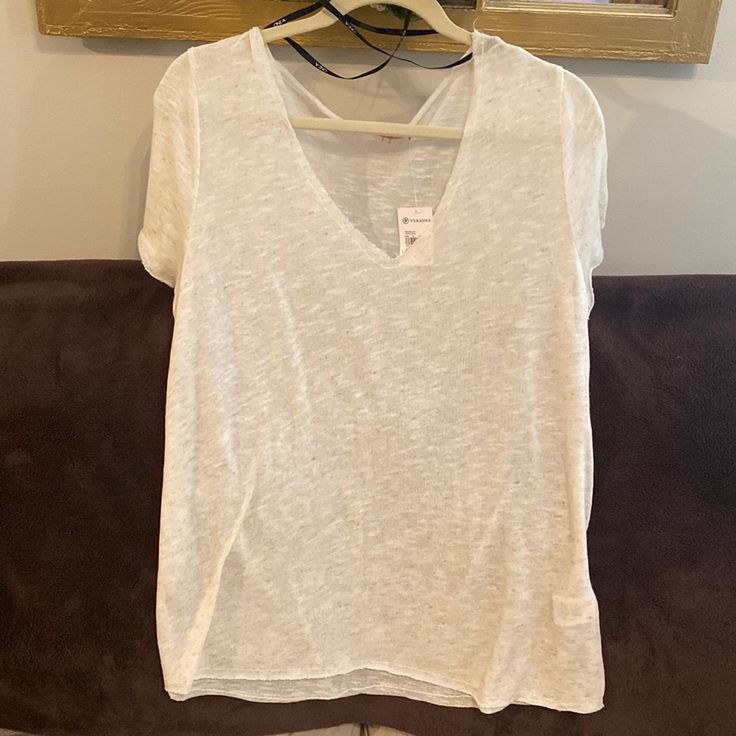 Super Cute Heathered Oatmeal Colored T-Shirt That I Got At Versona Boutique But Never Ended Up Wearing So It’s Still New With Tags. It’s A See Through Type Of Style/Fabric And Has A Raw Hem. I Had Planned To Wear It Oversized With A Sports Bra Or Cropped Tank Under It And Jeans. Very Cute And A Soft Material. Comes From A Smoke And Pet Free Home So Make Me An Offer! Casual Oatmeal Tops For Summer, Casual Oatmeal Summer Tops, Oatmeal Tops For Everyday Spring Wear, Oatmeal Tops For Spring Everyday Wear, Casual V-neck Short Sleeve Top For Loungewear, Casual White Relaxed Fit V-neck Top, Casual White V-neck Short Sleeve Top, Cream Short Sleeve Soft-washed Top, White Relaxed Fit V-neck Short Sleeve Top