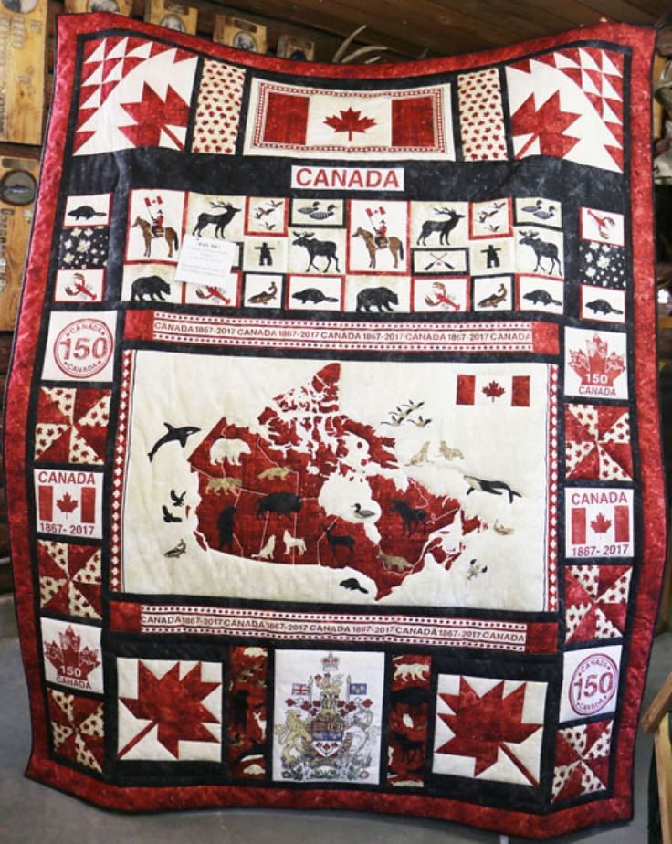 the canada quilt is hanging on the wall