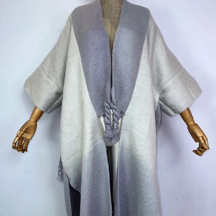 This super soft and warm wool cardigan kimono is perfect for the cold weather. Unlike other sweaters and wools, the wool used for this beauty is non itchy. Think of your favorite throw blanket, the comfort and warmth it gives but 10x stylish and wearable any where. This kimono is all that and more! One size fits S-4X Material: Wool One Size Fits Most Size Chart Wool Soft Knit Sweater Coat For Layering, Winter Layering Sweater Coat With Soft Texture, Winter Wool Sweater Coat With Soft Knit, Long Cashmere Sweater Coat For Winter, Merino Wool Sweater Coat With Shawl Collar For Winter, Cozy Merino Wool Sweater Coat For Cold Weather, Cozy One Size Gray Outerwear, Soft Knit Cashmere Sweater Coat For Winter, Winter Cashmere Sweater Coat With Soft Knit