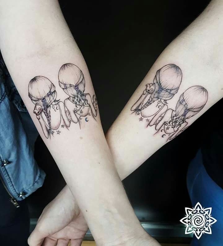 two people are holding hands with tattoos on their arms and one has a jellyfish