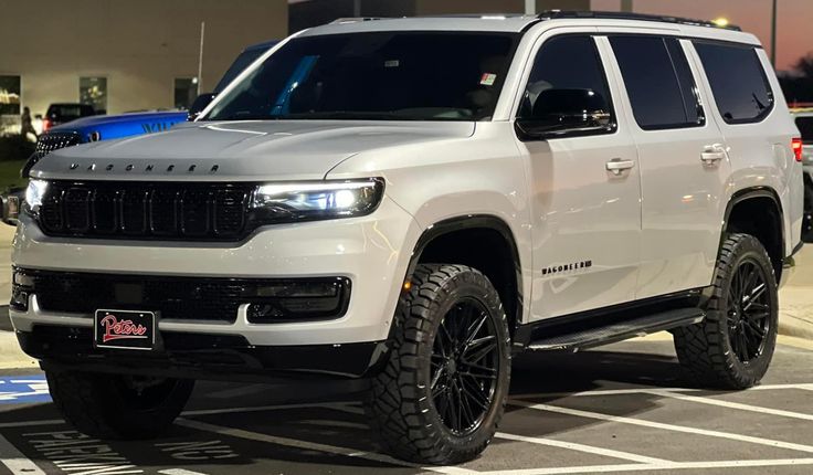 a white truck is parked in a parking lot