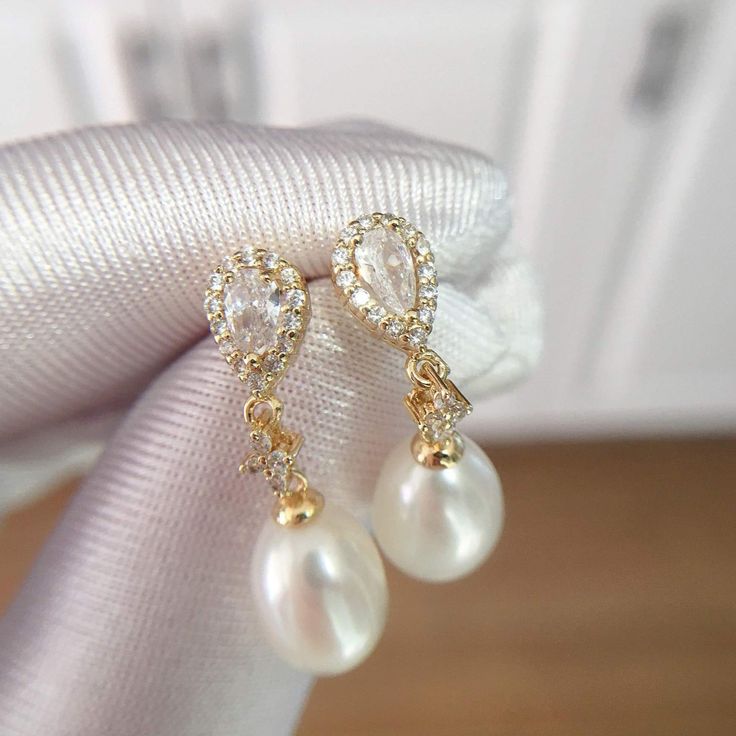 These stunning earrings feature lustrous oval pearls, accented with sparkling water drop-shaped zircons. The 18K gold plating adds a touch of modernity and makes them long-lasting, non-tarnishing for years! Pearl Type: Freshwater Pearls Pearl Quality: [Shape]: Oval [Size]: 8-9mm [Blemish]: None [Luster]: High Material: 18k Gold Plated Brass Note: Every pearl is unique. Items may vary from the pictures. Elegant Oval Pearl Charm Earrings, Elegant Oval Pearl Earrings With Pearl Charm, Elegant Teardrop Pearl Earrings With Cubic Zirconia, Elegant Gold Pear-shaped Bridal Earrings, Elegant Oval Pearl Earrings, Elegant Oval Gold Plated Earrings, Elegant Gold Plated Teardrop Earrings For Formal Occasions, Elegant Oval Teardrop Earrings For Formal Occasions, Gold Plated Teardrop Pearl Earrings