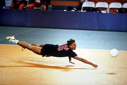 a man dives to catch a ball during a game