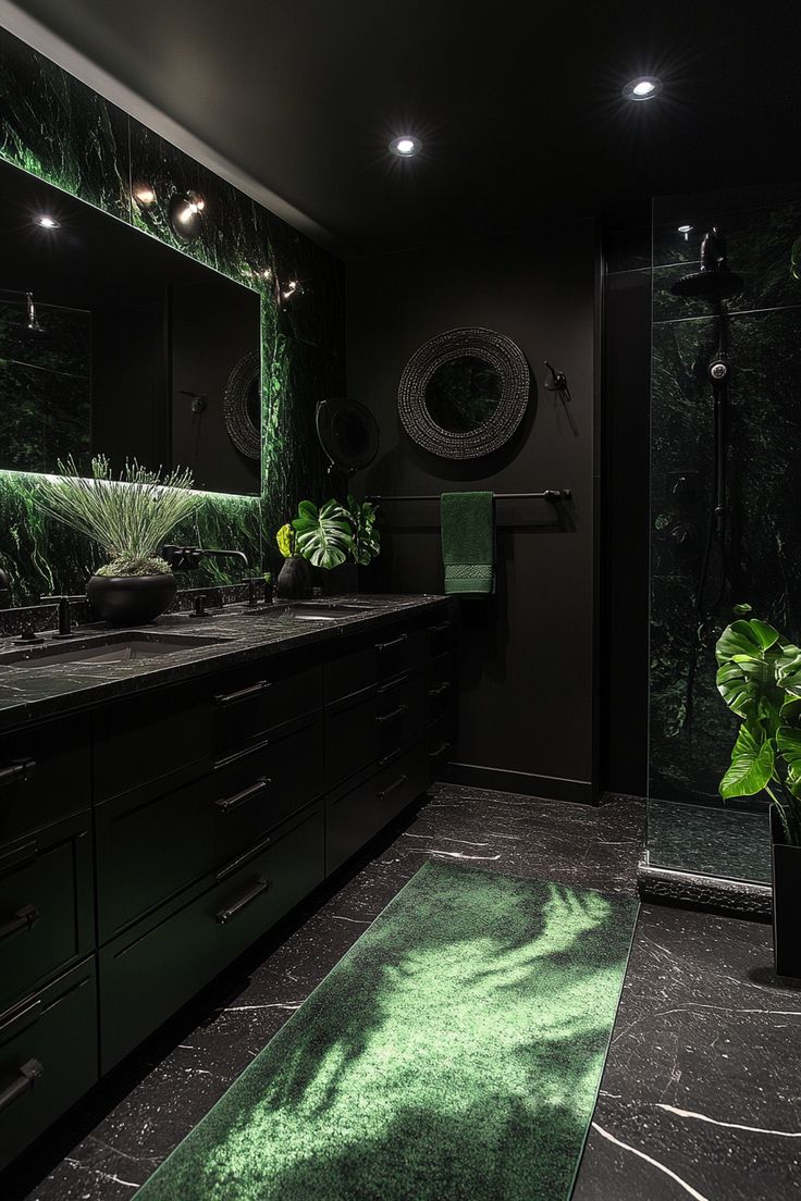 a black bathroom with green lighting and plants on the counter top, along with dark cabinets