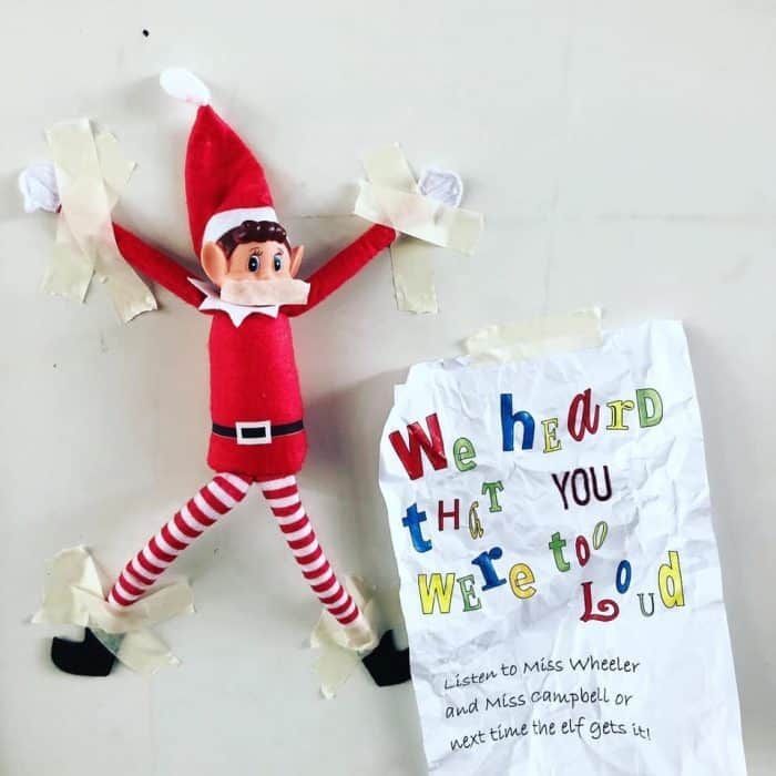 an elf is laying on the floor next to a sign that says, we heard what you were to do