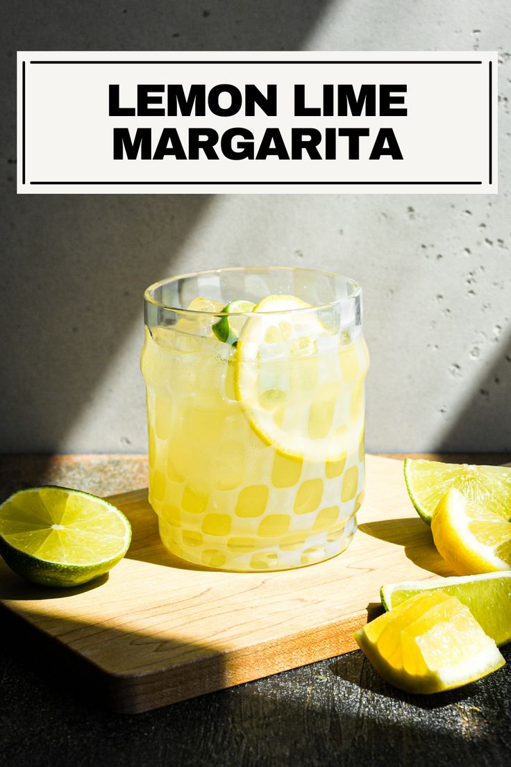 a lemon lime margarita sitting on top of a cutting board