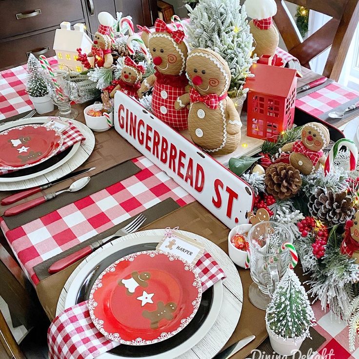 a table set for christmas with gingerbreads and other holiday decorations on top of it