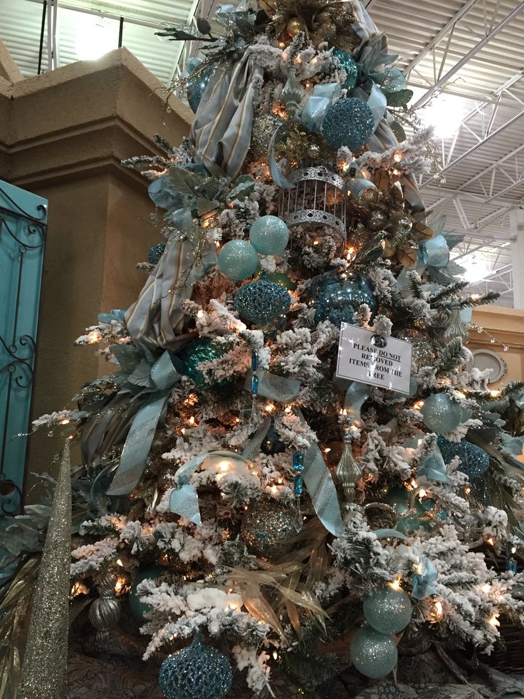 a decorated christmas tree with blue and silver ornaments