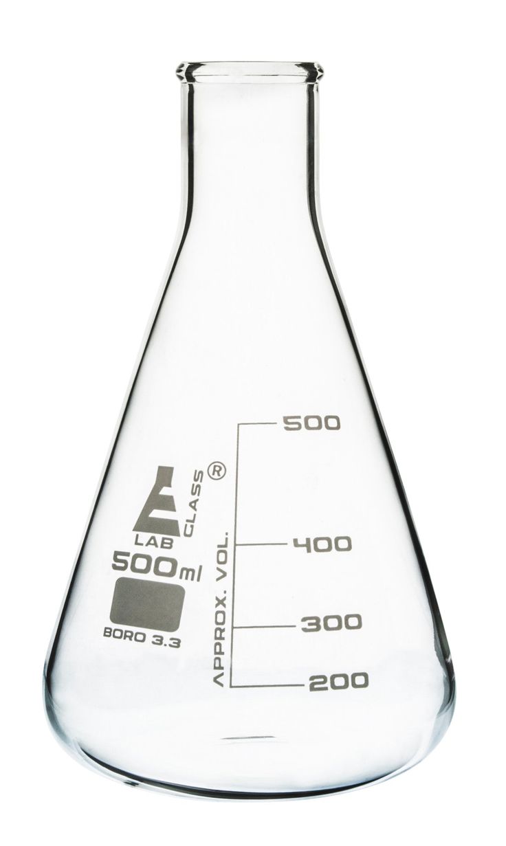 a flask filled with liquid on top of a white table next to a measuring cup