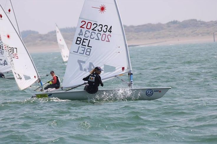 two people on small sail boats in the water