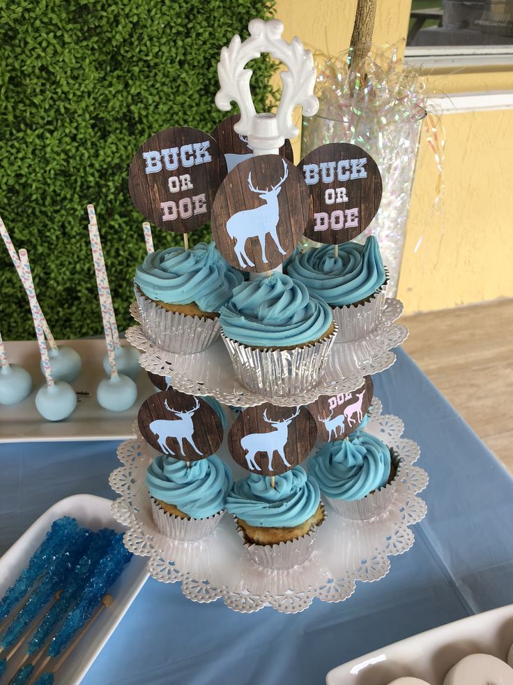 cupcakes are stacked on top of each other in front of a cake stand