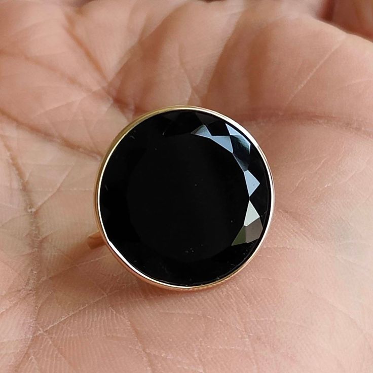 ITEM DESCRIPTION: The Ring is made from Solid 14K Yellow Gold. Gemstone used is absolutely natural and ethically sourced. Natural Black Onyx in round shape and Flat cut is studded on it with utmost precision. Gem: Black Onyx Gem size: 20 mm and Round Shape Gem weight: 8.50 carats Gold purity: 14K (58.33% approx.) Gold weight: 2.11 grams Gross weight : 3.810 grams The Gold purity is guaranteed and it comes with authentic 14K gold hallmark. Since these Rings are handmade, they are Nickel/Lead FREE Black Round Ring With Bezel Setting, Black Round Rings With Bezel Setting, Fine Jewelry Black Rings With Bezel Setting, 14k Gold Black Ring With Bezel Setting, Fine Black Rings With Bezel Setting, 14k Gold Black Rings With Bezel Setting, Classic Black Jewelry With Round Stone, Black Rings With Round Gemstone, Black Faceted Rings For Gift