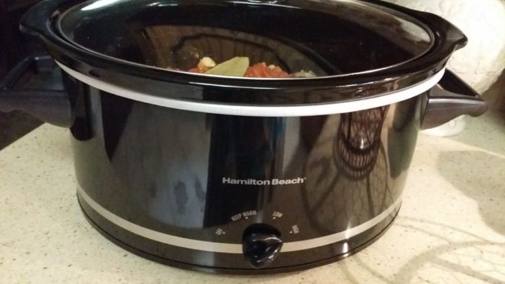 a crock pot filled with food sitting on top of a counter