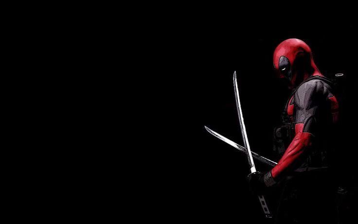 a man in a deadpool costume holding two swords and looking at the camera while standing against a black background