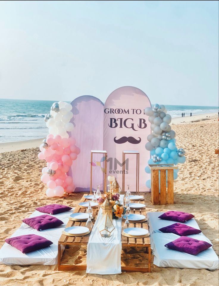 a table set up on the beach for a wedding