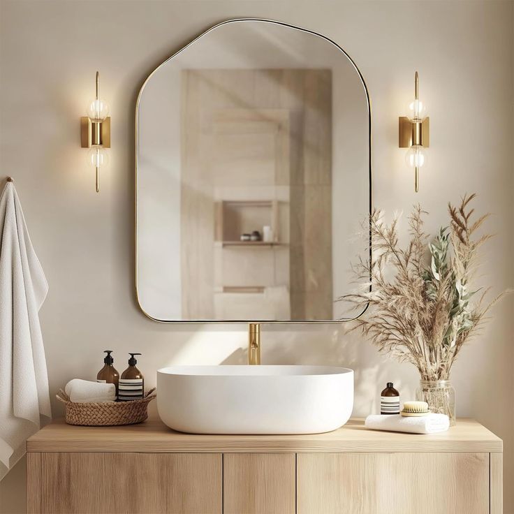 a bathroom with a sink, mirror and towels on the counter in front of it