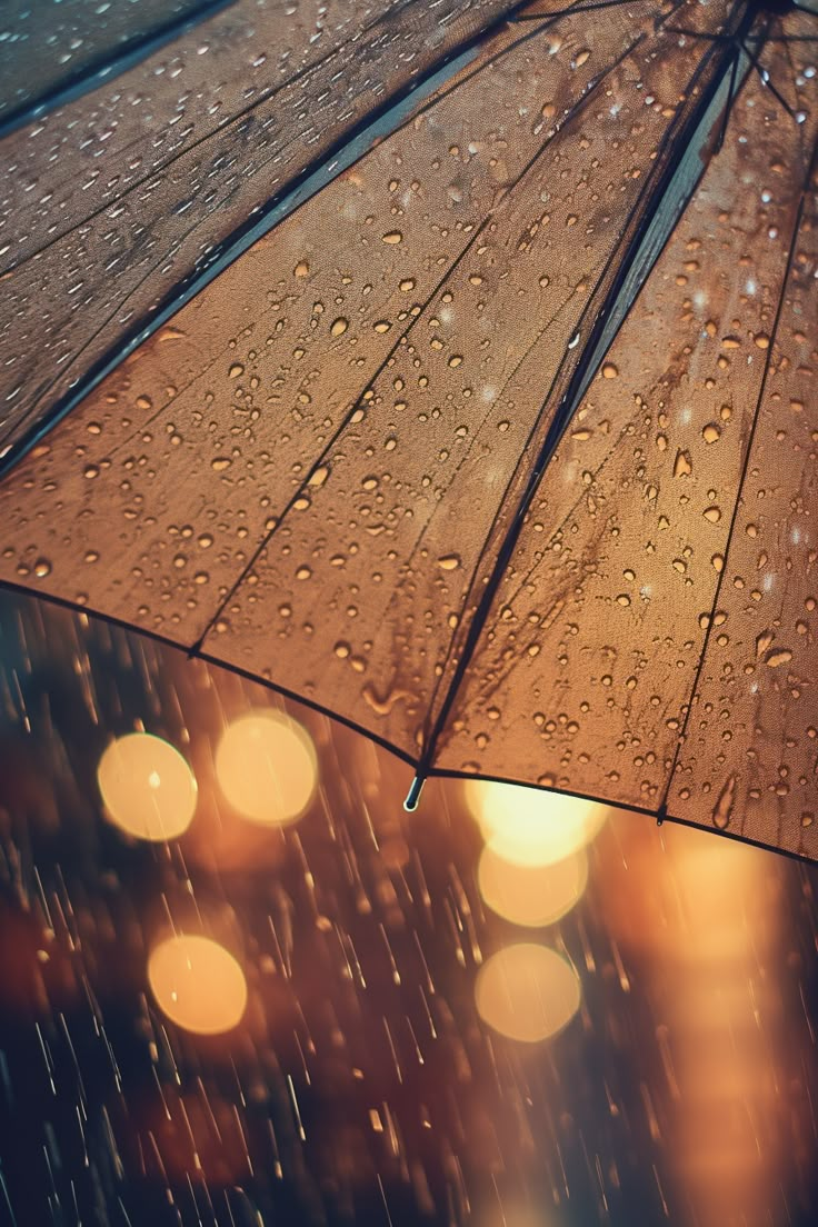 an open umbrella with rain drops on it