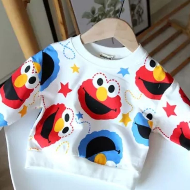 Brand New Elmo & Cookie Monster Sweater. Size: Xlarge (110cm) Color: White Long Sleeve T-shirt With Character Print For Playtime, Long Sleeve Cotton T-shirt For Playwear, Fun Long Sleeve T-shirt For Playtime, Multicolor Long Sleeve Top With Cartoon Print, Winter Character Print Long Sleeve Tops, Winter Long Sleeve Tops With Character Print, Winter Cotton Sweater With Character Print, Cotton Winter Sweater With Character Print, Playful Multicolor Long Sleeve Sweatshirt