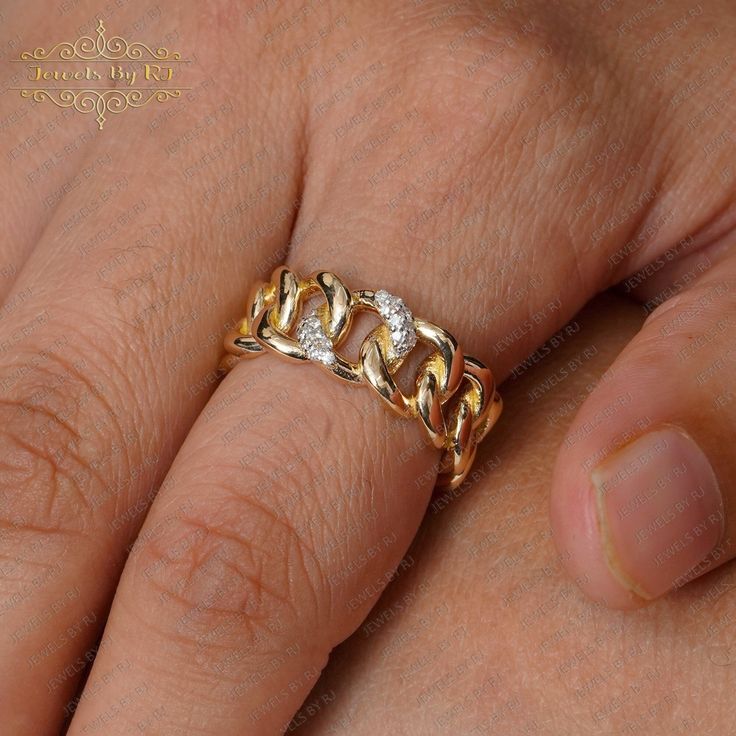 a close up of a person's hand with a gold ring on their finger