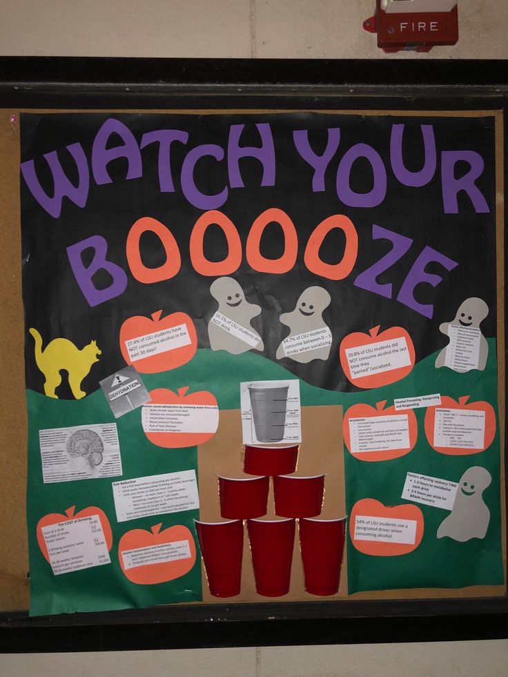 a sign that says watch your booze with red cups in front of it and halloween decorations