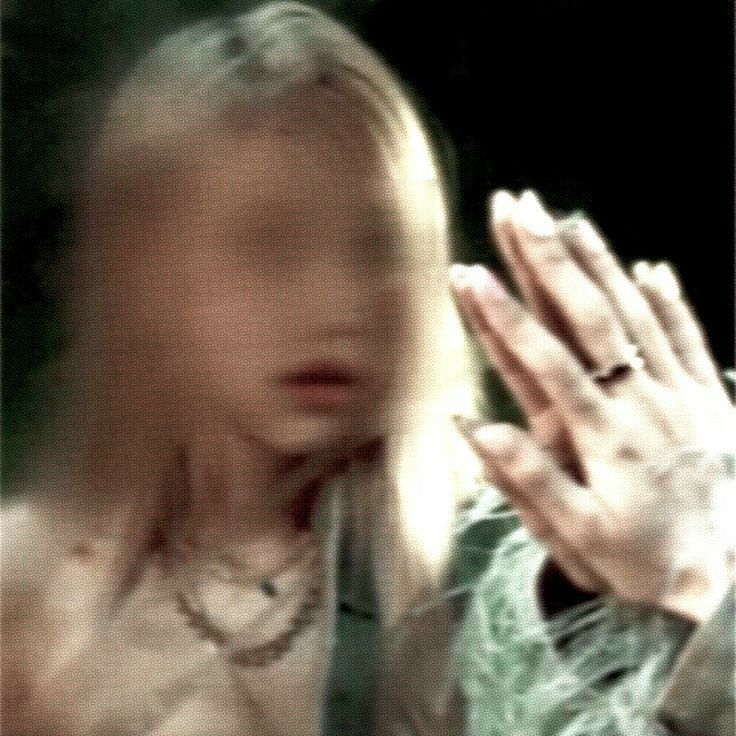 a blurry image of a woman holding her hands together