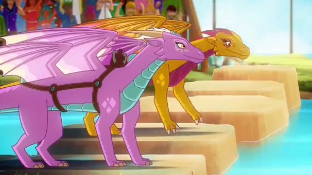 the pink and yellow dragon are standing next to each other in front of a group of people