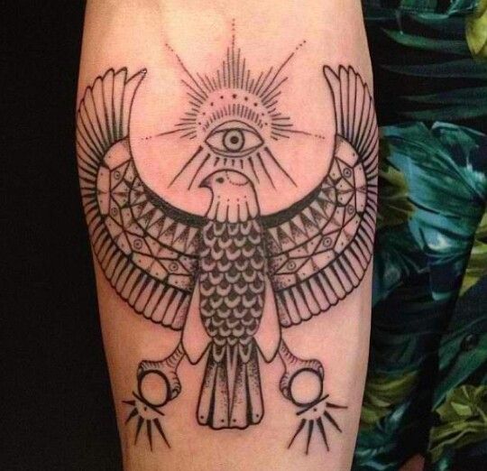 a bird with an all seeing eye tattoo on it's arm