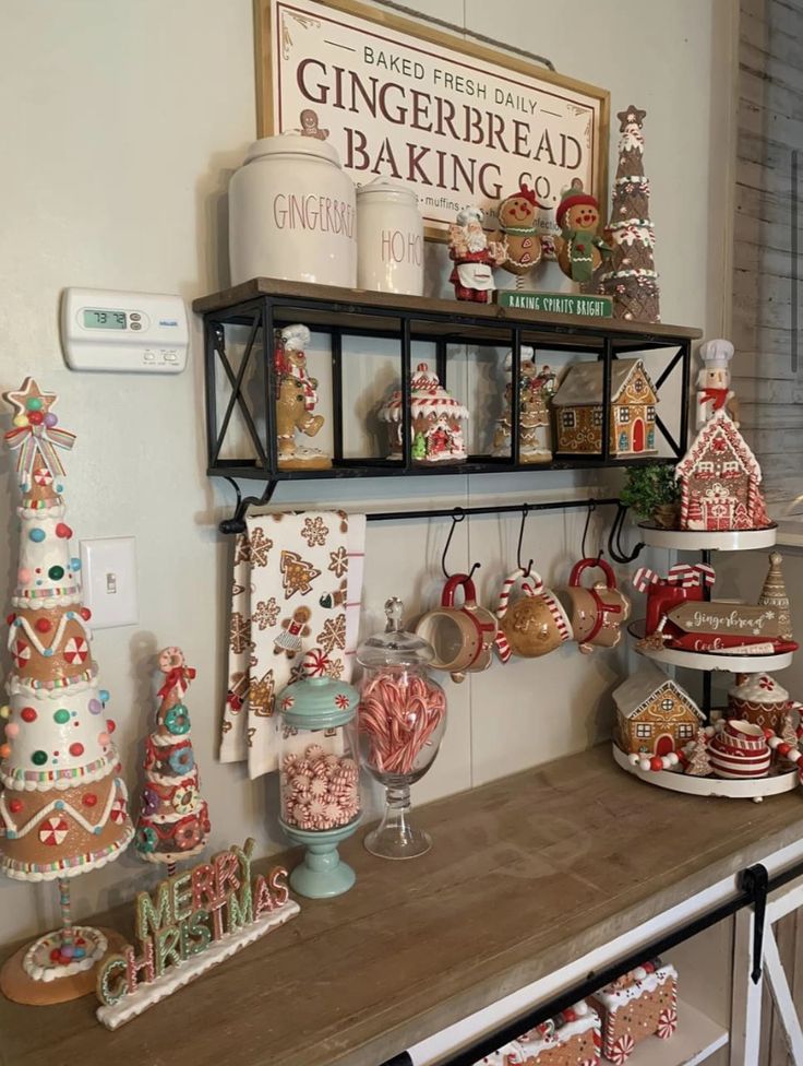 an assortment of gingerbreads and other holiday treats are displayed on a shelf in the kitchen