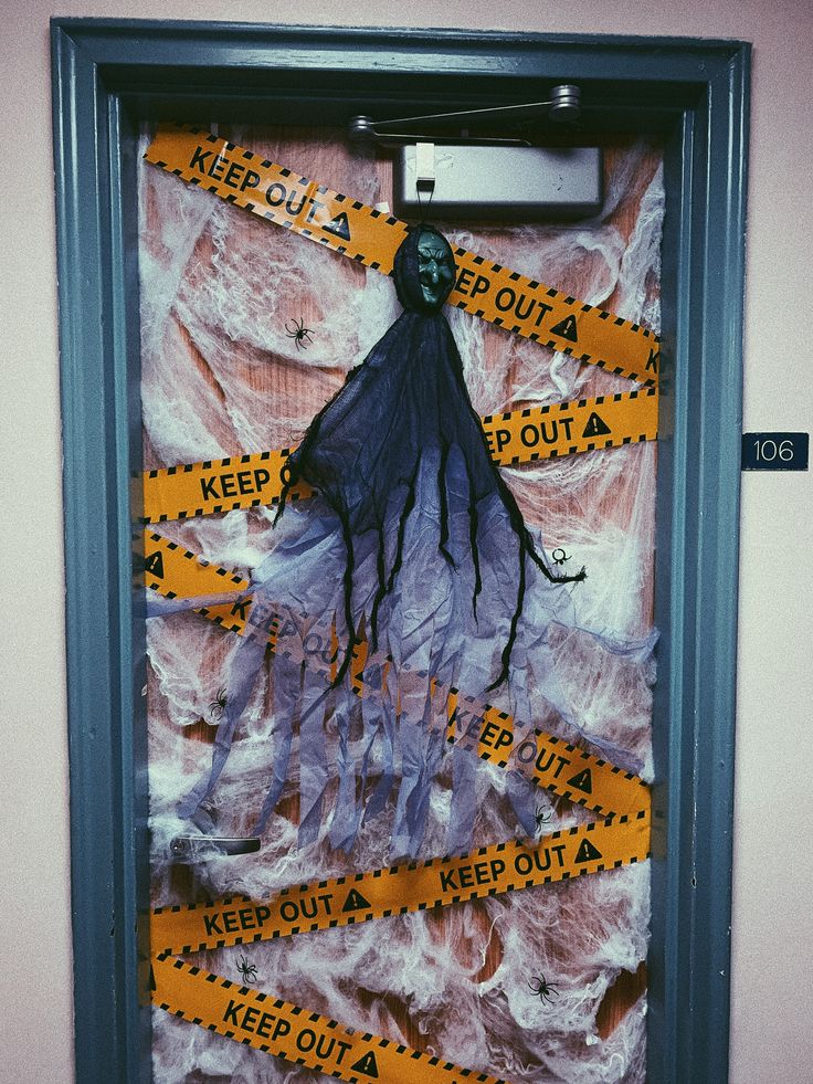 a door with tape taped around it and a hand hanging on the wall