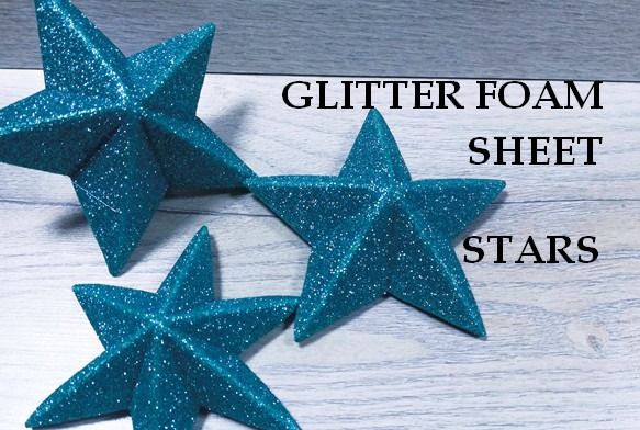 three blue glitter stars on a white wood background with text overlay that reads glitter foam sheet stars