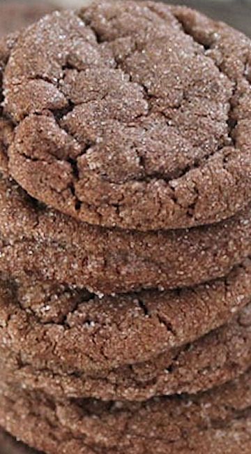 a stack of chocolate cookies sitting on top of a wooden table