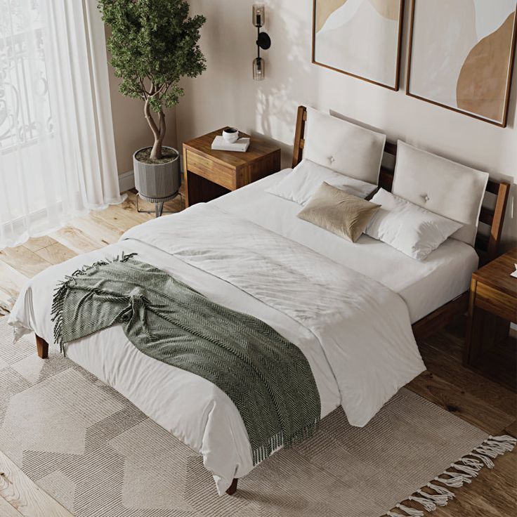 a large bed sitting in a bedroom on top of a wooden floor