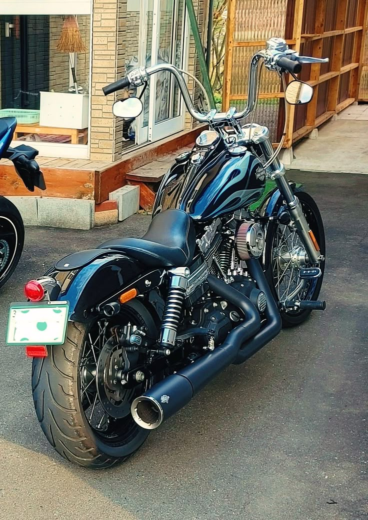 two motorcycles parked next to each other in front of a building