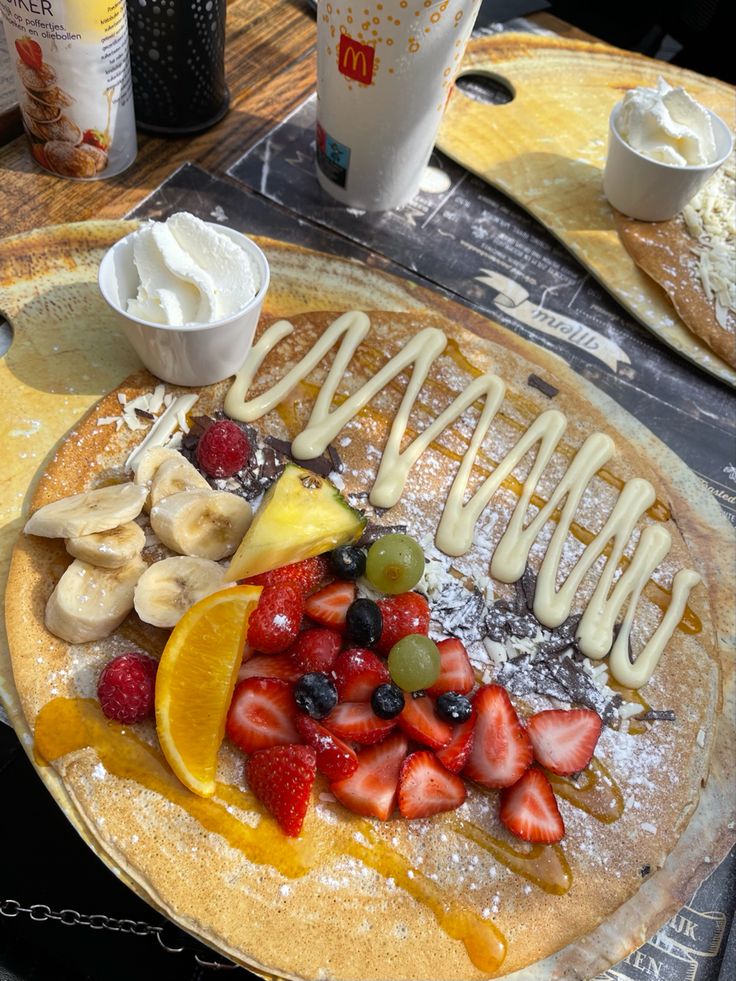 a pancake with fruit and cream on it