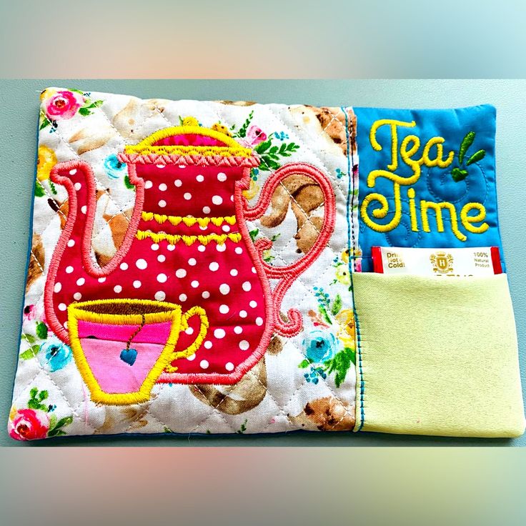 a close up of a pillow with a tea pot on it