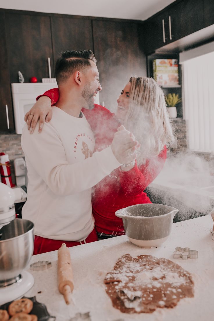 a man and woman are in the kitchen cooking some food with steam coming out of their mouths