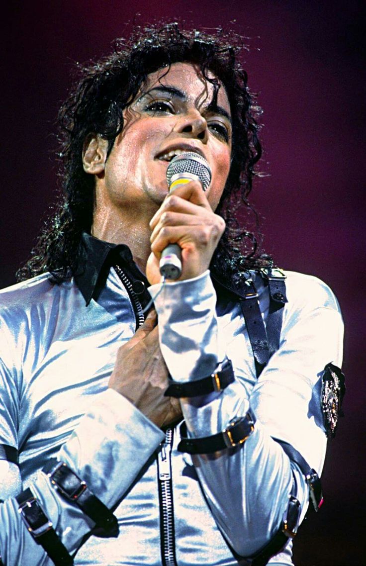 michael jackson singing into a microphone on stage