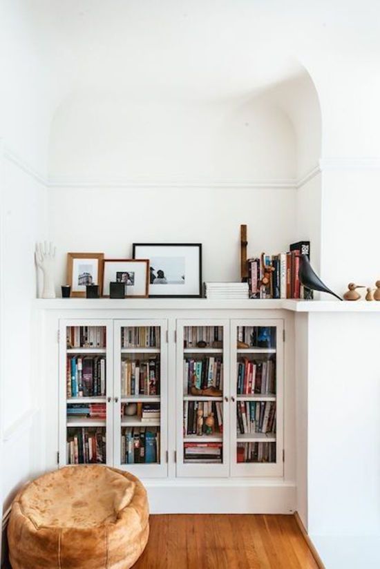 a white bookcase filled with lots of books