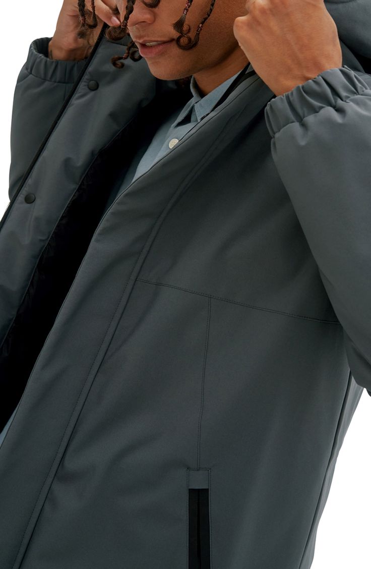 A warm insulated coat that is fitted with a hood and zipper pockets, with a shell that will shield you from conditions up to -15°C/5°F. 32" Length (size M) Attached hood Long sleeves Zipper front Dual zipper pockets Solid Woven Fully lined Shell: 100% polyester; lining: 100% synthetic filling Machine wash, line dry Imported Model stats: 6'1" height, 32" waist. Model is wearing size M. Waterproof Solid Outerwear For Cold Weather, Waterproof Outerwear For Cold Weather, Solid Nylon Outerwear With Fleece Lining, Long Solid Puffer Jacket With Detachable Hood, Solid Windbreaker With Detachable Hood For Cold Weather, Solid Color Windbreaker With Detachable Hood For Cold Weather, Hooded Puffer Jacket For Work, Winter Workwear Nylon Raincoat, Hooded Puffer Jacket With Padded Collar For Workwear