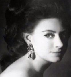 a black and white photo of a woman wearing earrings