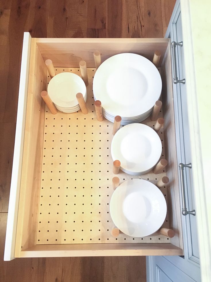 an overhead view of dishes and utensils in a drawer