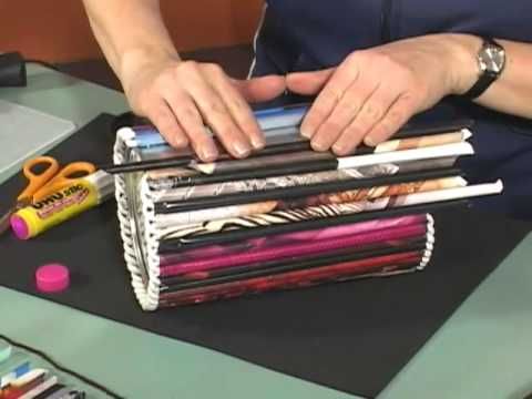 a person sitting at a table with several different types of magazines and scissors in front of them