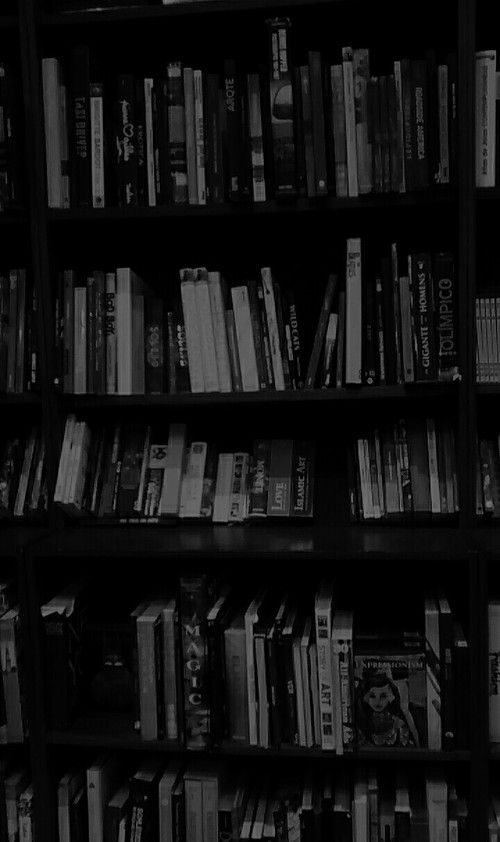 black and white photo of bookshelves in a library