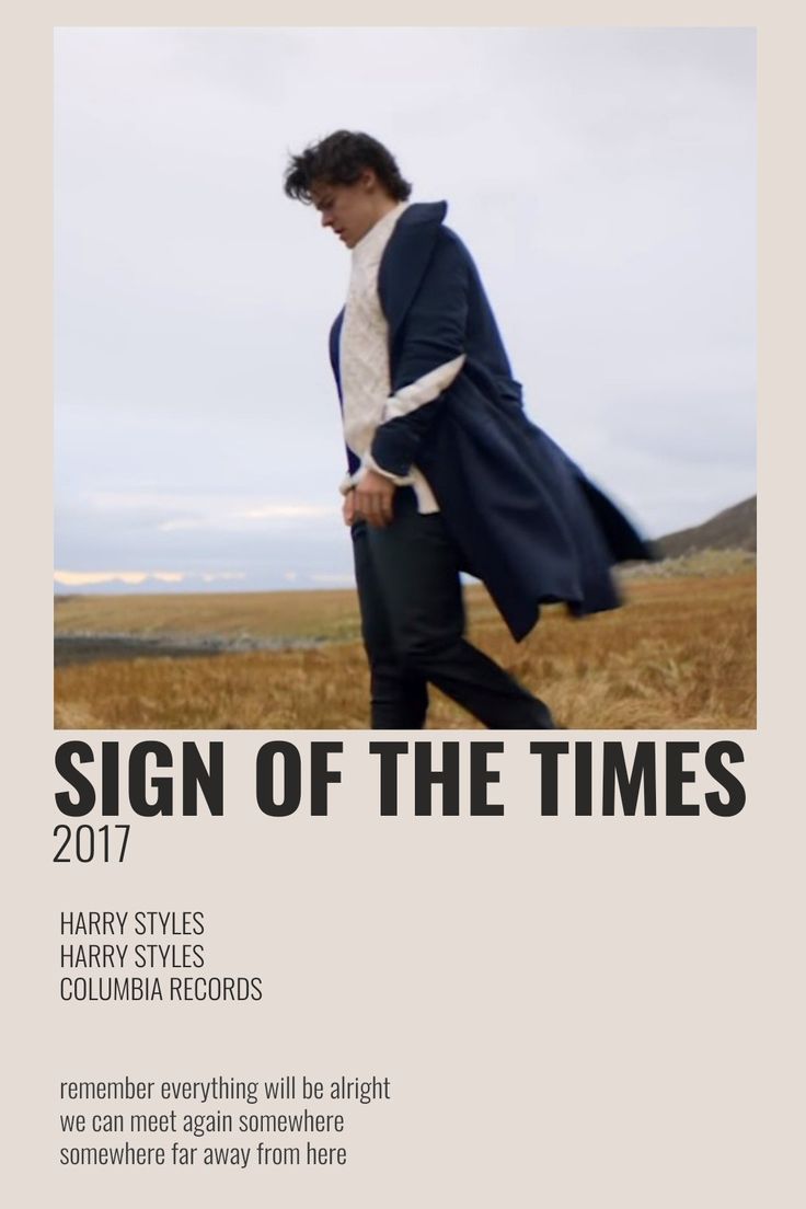 a man walking across a field in front of a sign that says sign of the times