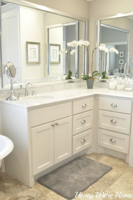 a white bathroom with two sinks and mirrors