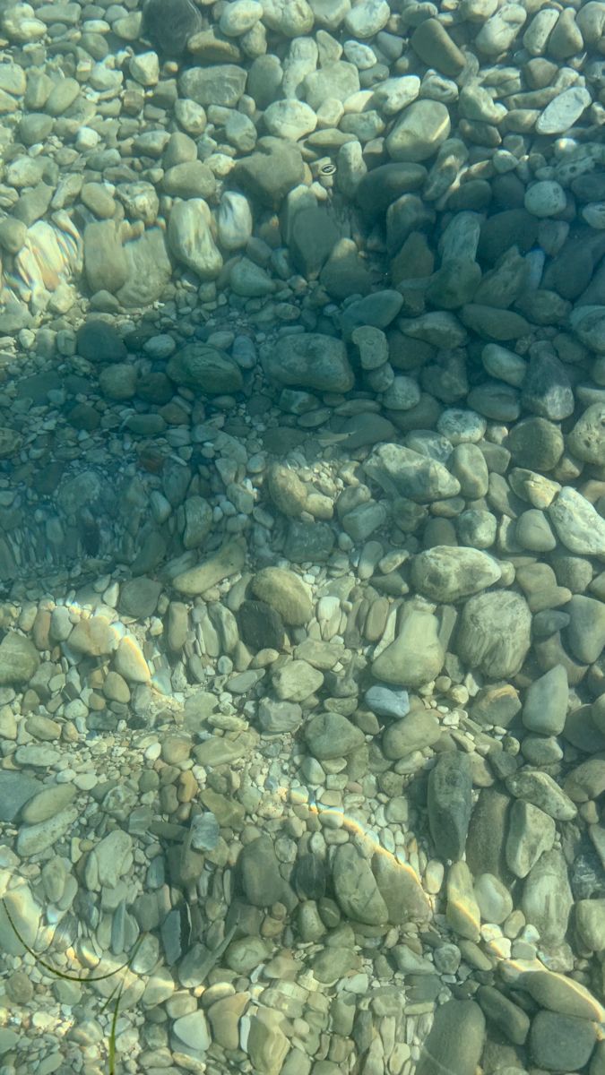 the water is crystal clear and there are rocks in it