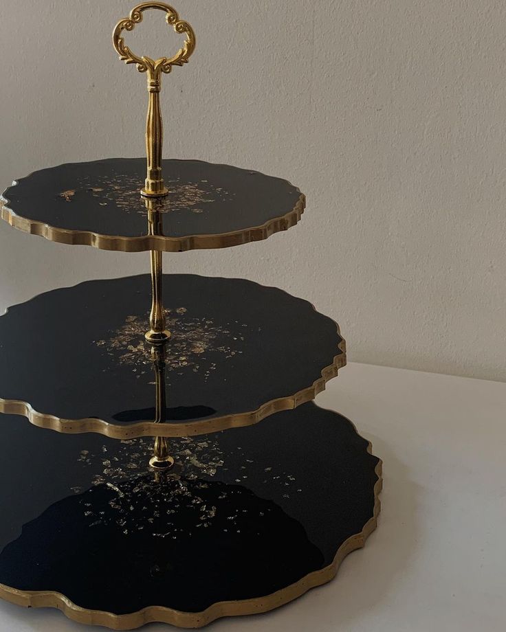 three tiered black and gold serving tray