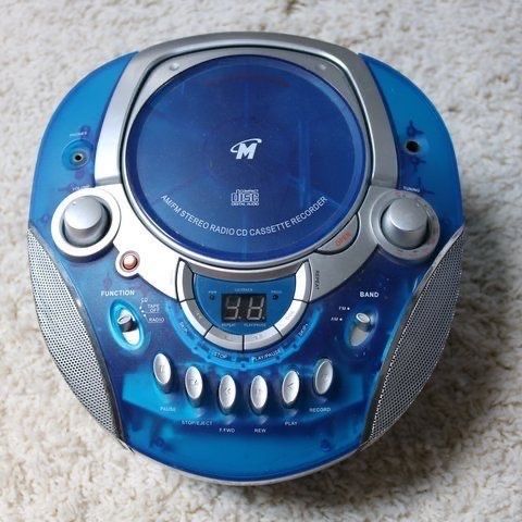 a blue and silver radio sitting on top of a white carpet