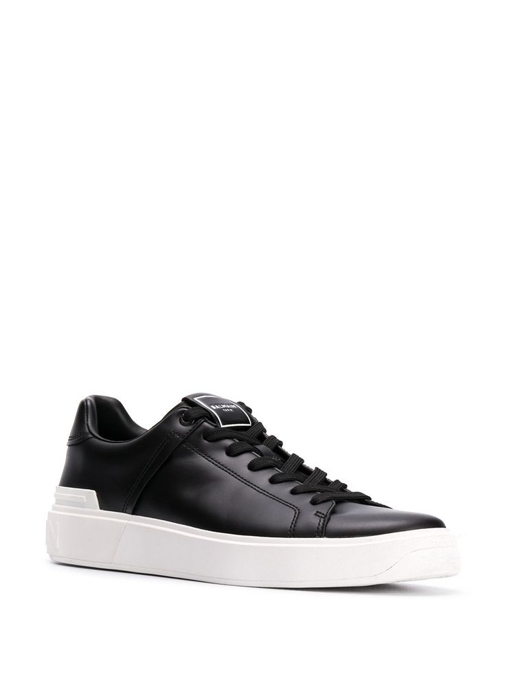 Balmain B-Court low-top Sneakers - Farfetch Luxury Low-top Sneakers With Textured Sole, Designer Lace-up Sneakers With Vulcanized Sole, Designer Sneakers With Vulcanized White Sole, Black Low-top Calf Leather Sneakers, Textured Sole Calf Leather Sneakers For Streetwear, Calf Leather Sneakers With Textured Sole For Streetwear, Calf Leather Sneakers With Contrast Sole For Streetwear, Streetwear Sneakers With Textured Sole And Calf Leather, Streetwear Calf Leather Sneakers With Textured Sole